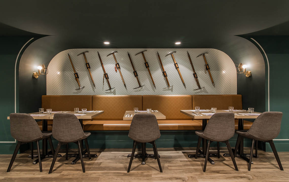 Tables set with ice picks on display on the wall in the background