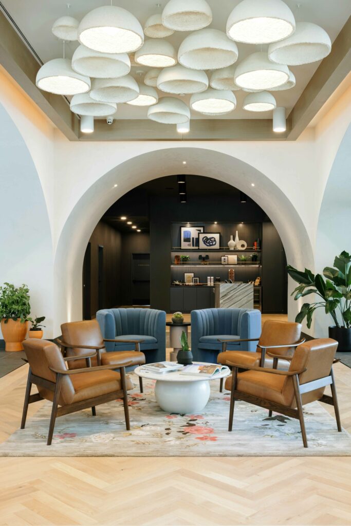 Assorted chairs arranged around a white coffee table in a hotel lobby
